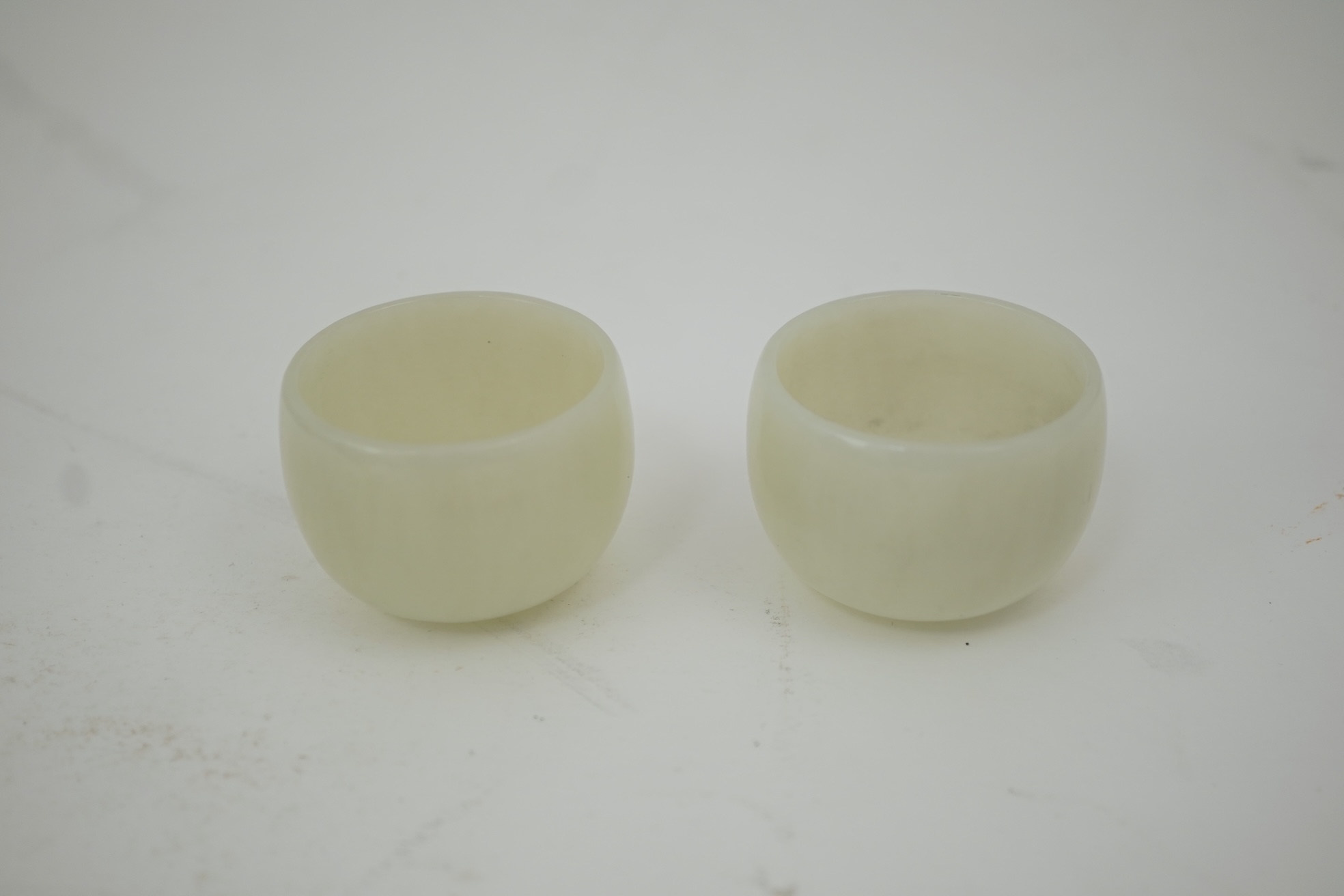 A pair of Chinese white jade cups, Qing dynasty or later